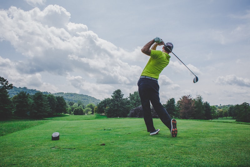 People playing golf on a green course